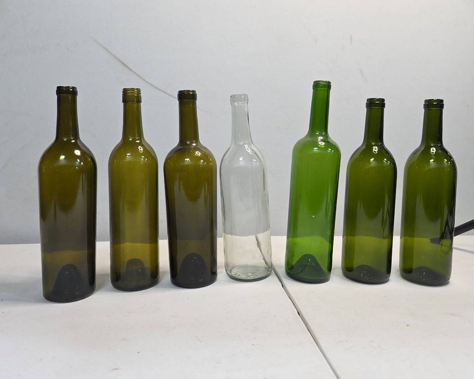 7 Assorted 750 ml Glass Bottles Including Clear and Green Wine Bottles
