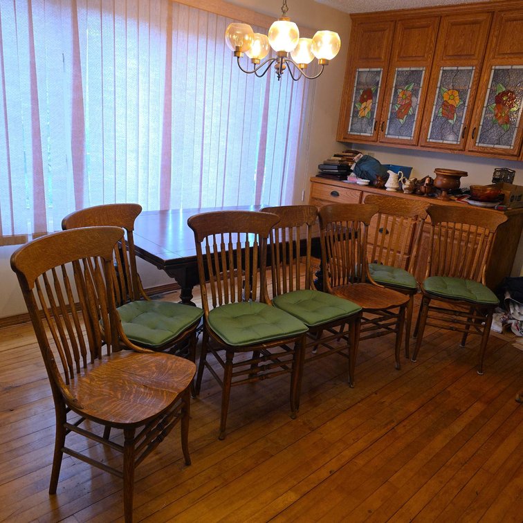 7 Oak Dining Chairs with Vertical Slat Backs and Green Cushions, 38" Tall Each