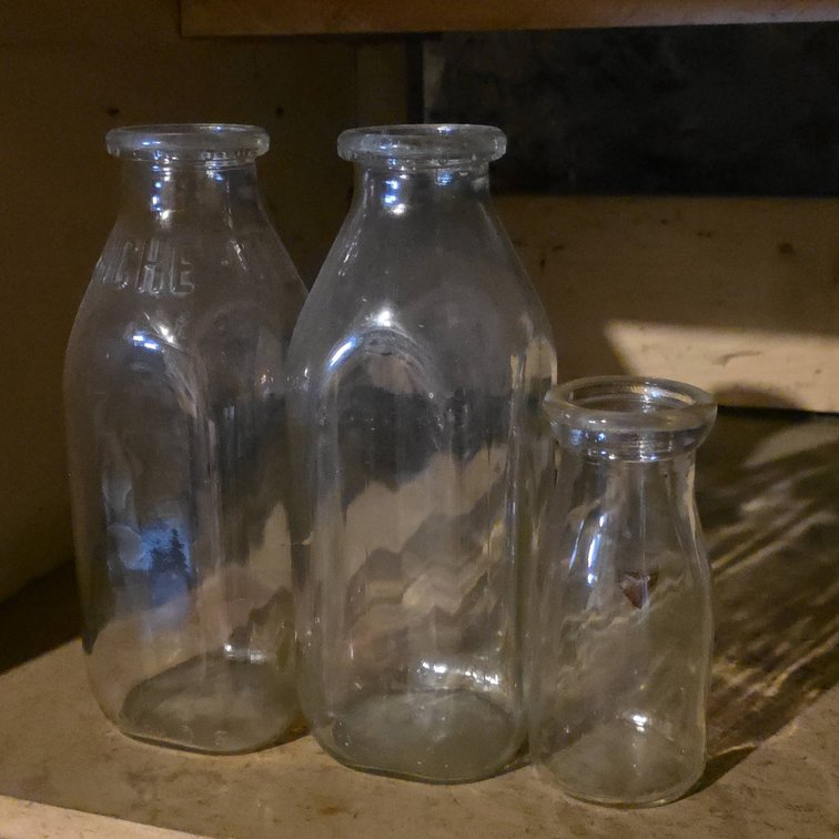 Three Clear Glass Milk Bottles, One Embossed "DELWICHE" One Quart