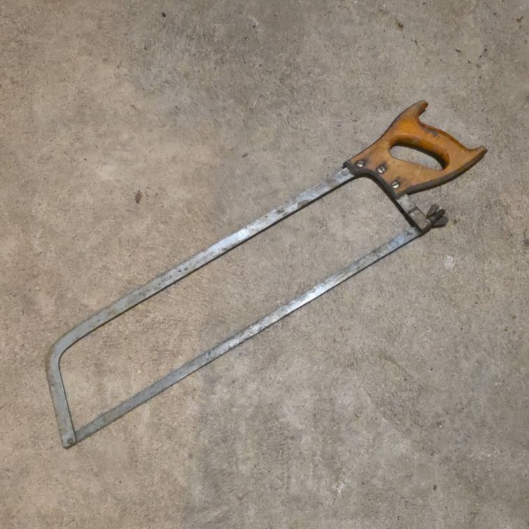 24-Inch Steel Frame Hand Saw with Wooden Handle and Wing Nut, Shows Signs of Use, Functional