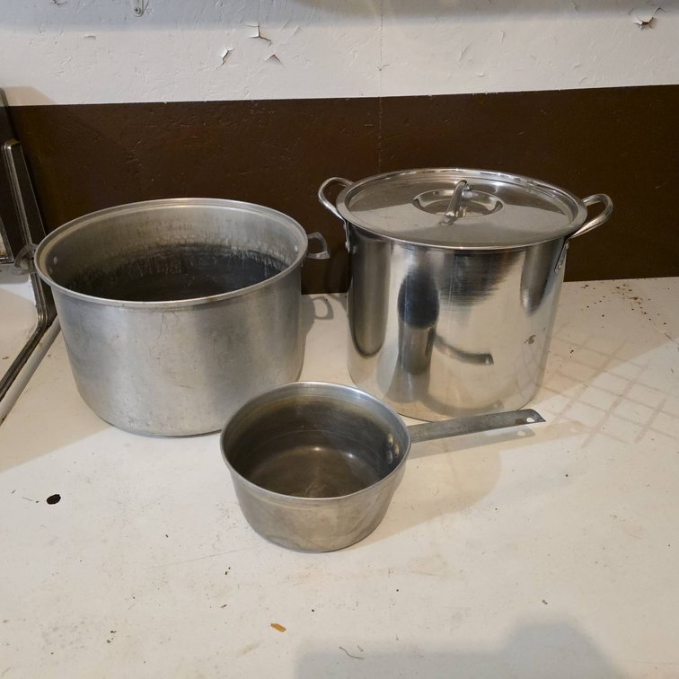 Three Stainless Steel Pots with Lids Including Large Stock Pot, Medium Pot, and Small Saucepan