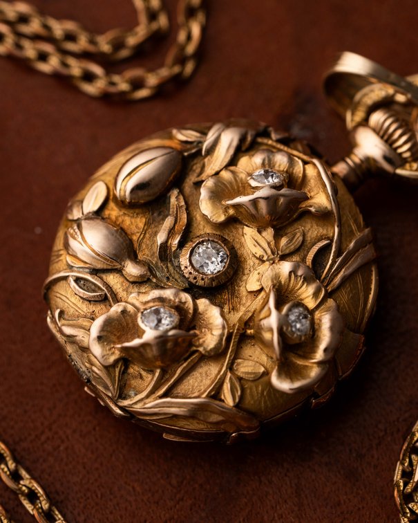 Swiss, miniature pendant watch, 18K high relief w/diamonds