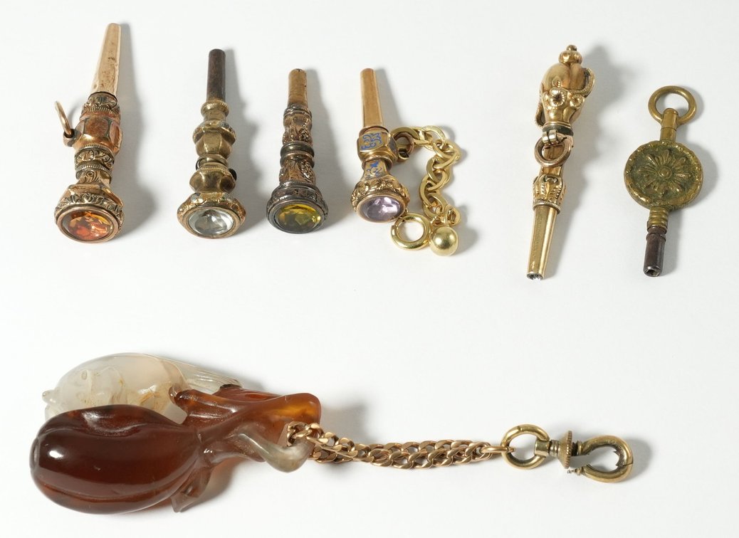 Lot (7) Six antique PW keys & one carved stone pendant