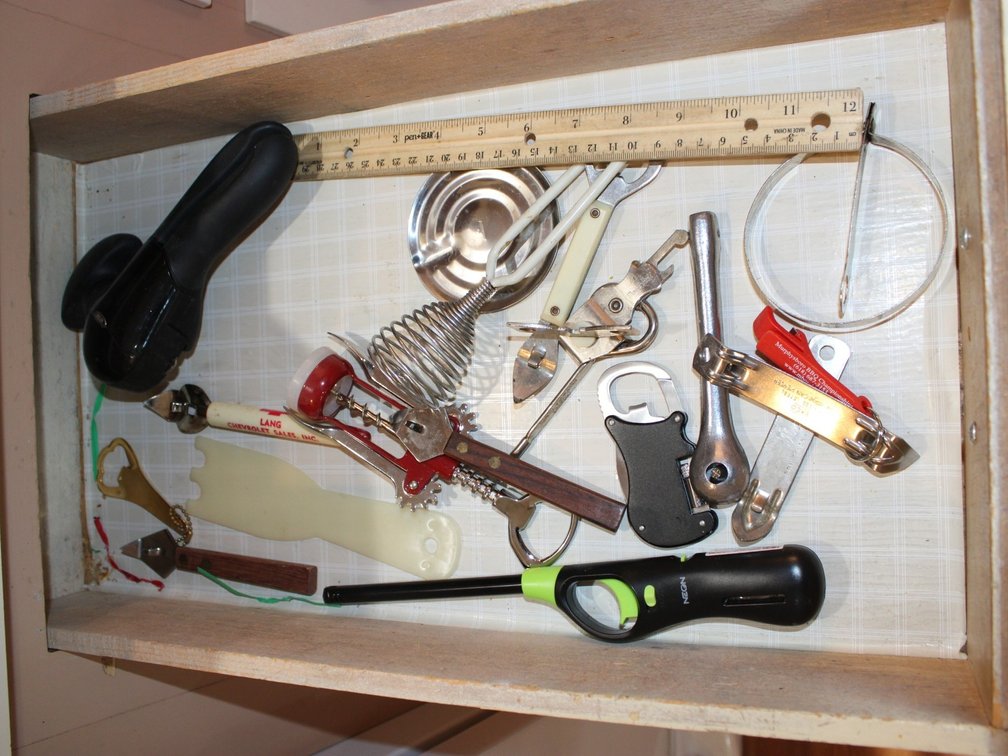 Contents Of Three Kitchen Drawers To Include, Bottle Openers, Kitchen Utensils, Skewers, Etc.