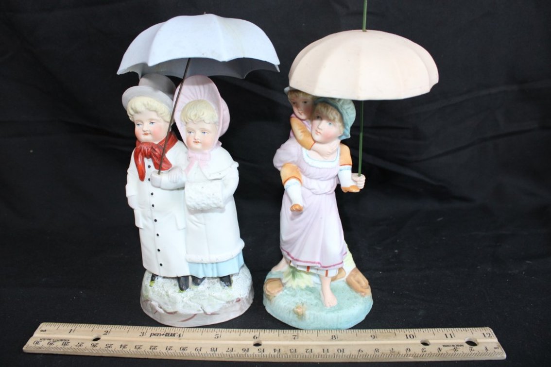 Two Umbrella Figurines.