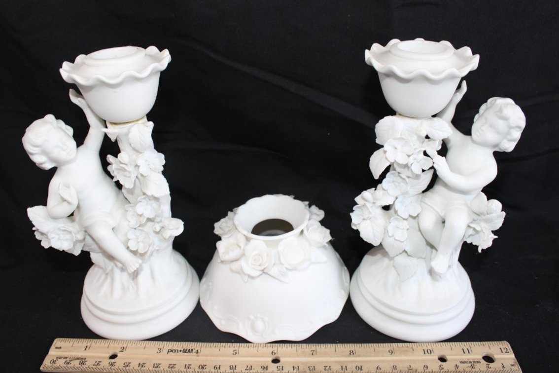 Two Cherub Candle Holders And An Odd Candle Shade.