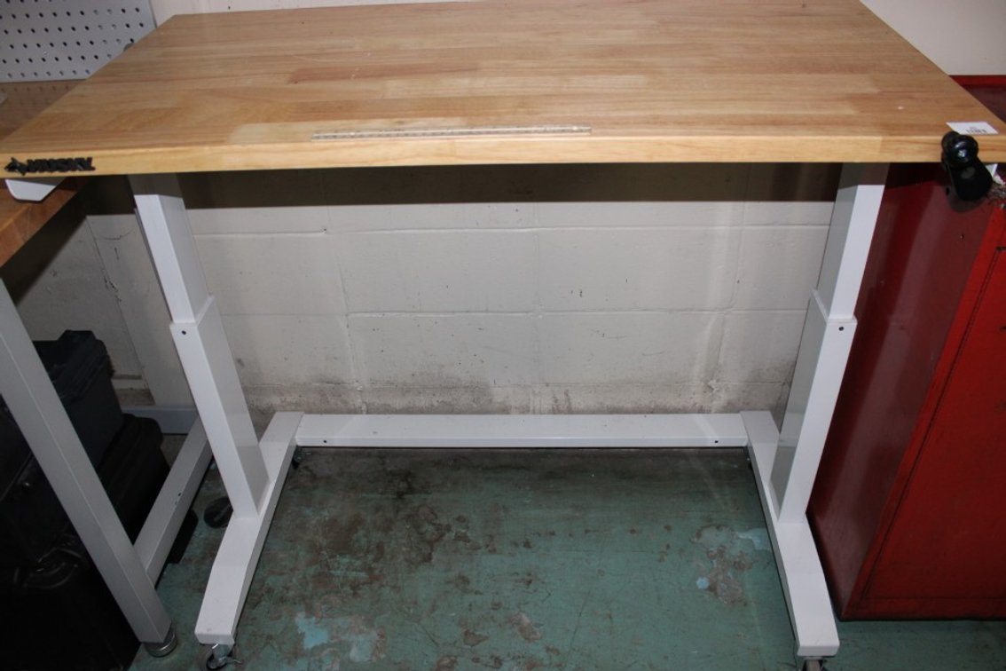 Husky Rolling Adjustable Work Table. Measures 46 By 24 Is 29 Tall At Its Lowest Point And 42 Tall At Its Tallest Point.