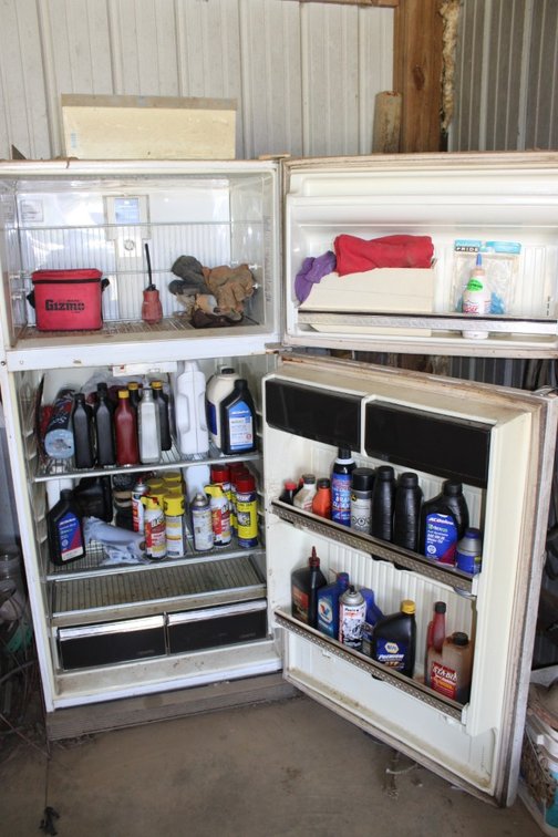 Farm and Automotive Oils and Chemicals In a Non-Working Refrigerator