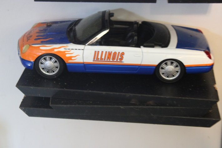 Image for Four Diecast Cars and Display Shelves. Three Are 1:32 Scale, One Is 1:24 Scale. Signature 1961 Chevy Impala, New Way 1970 Dodge Challenger, Signature 1963 Studebaker Missing a Wheel, and 2004 Thunderbird Fighting Illini