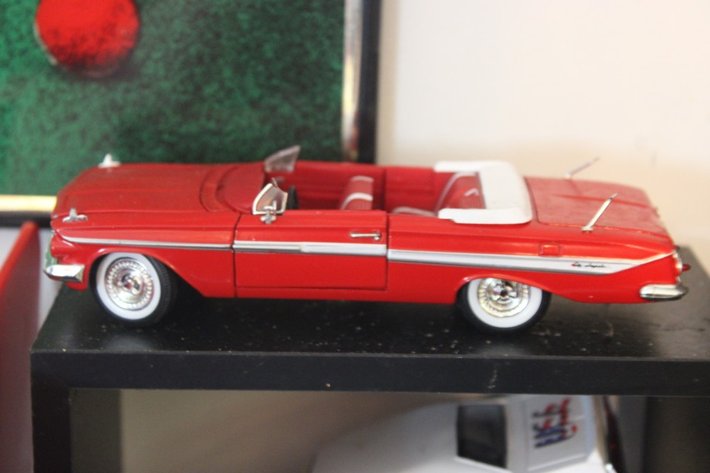 Image for Four Diecast Cars and Display Shelves. Three Are 1:32 Scale, One Is 1:24 Scale. Signature 1961 Chevy Impala, New Way 1970 Dodge Challenger, Signature 1963 Studebaker Missing a Wheel, and 2004 Thunderbird Fighting Illini