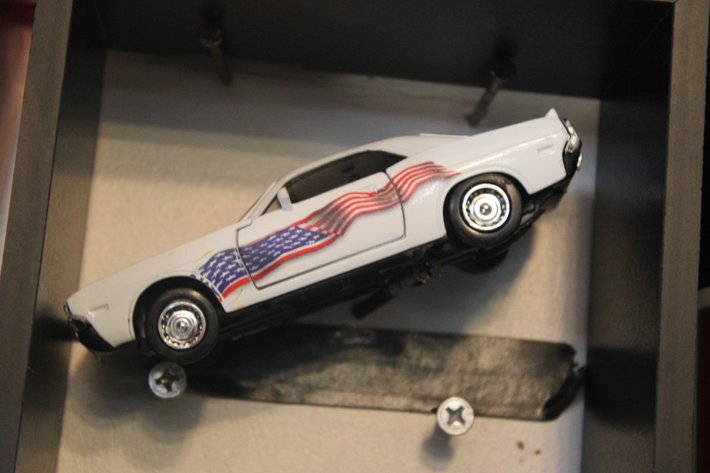 Image for Four Diecast Cars and Display Shelves. Three Are 1:32 Scale, One Is 1:24 Scale. Signature 1961 Chevy Impala, New Way 1970 Dodge Challenger, Signature 1963 Studebaker Missing a Wheel, and 2004 Thunderbird Fighting Illini