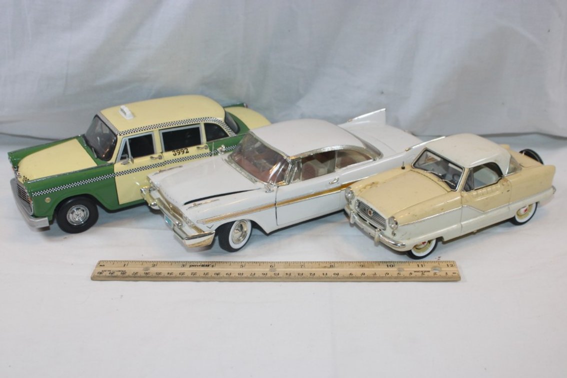 Three Cars, Two 1:18 Scale and One 1:24 Scale, 1957 Plymouth Fury, 1959 AMC Metropolitan, 1961 Checker A11