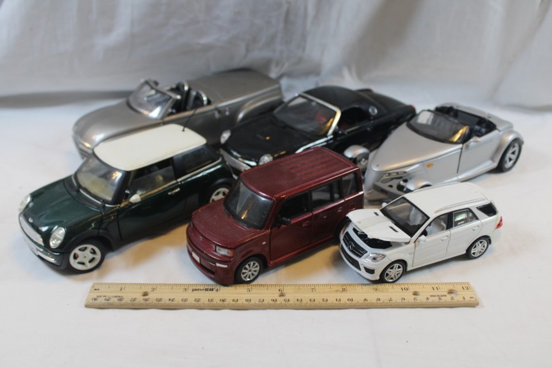 Six Diecast Cars, Plymouth Prowler Maisto, 1:18 Scale Thunderbird, 1:18 Scale Mini Cooper, 1:18 Scale 2000 Chevy SSR, 1:24 Scale Scion xB, and 1:32 Scale Mercedes