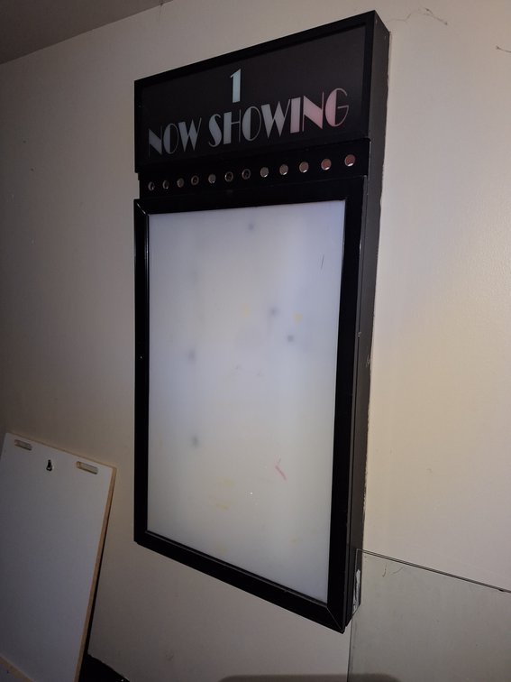 "Now Showing" Lighted Theater Entrance Movie Poster Holding Signs