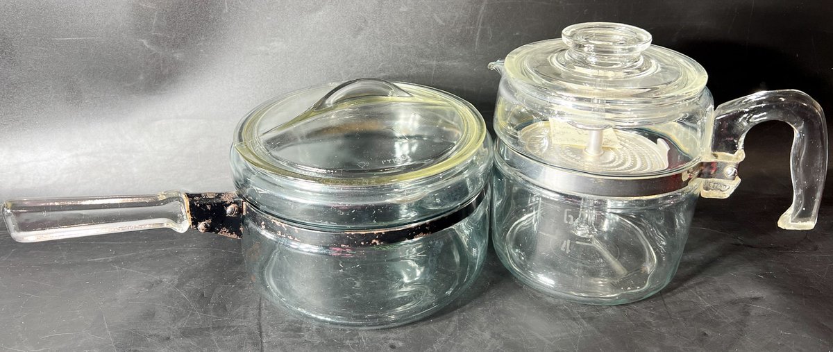 Two Clear Glass Cookware Items with Metal Trim and Handles