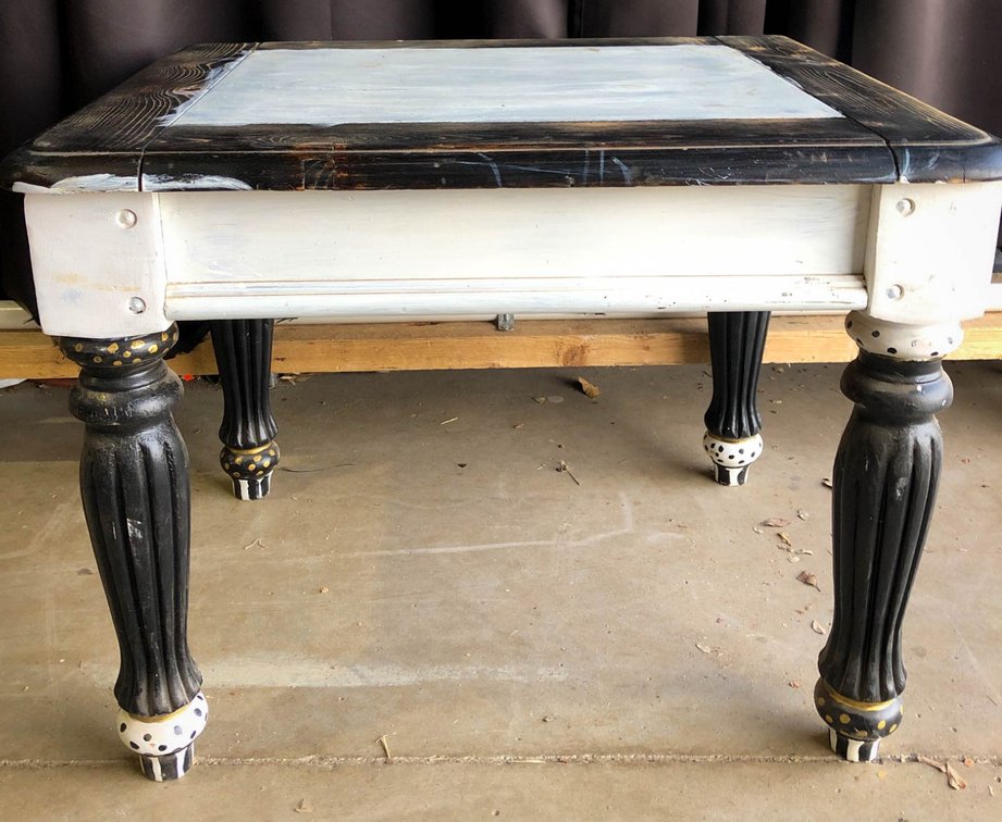 Black and White Wooden Table with Fluted Legs and Casters