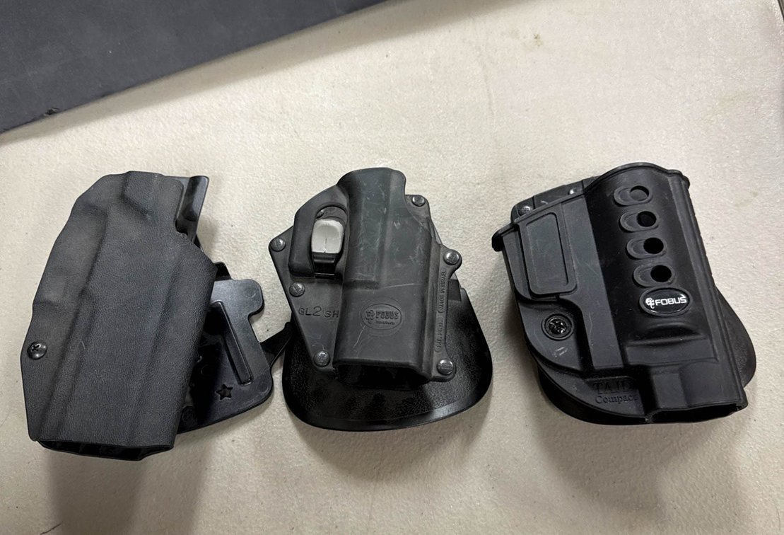 Three Pistol Holsters Including Fobus and We The People Holsters