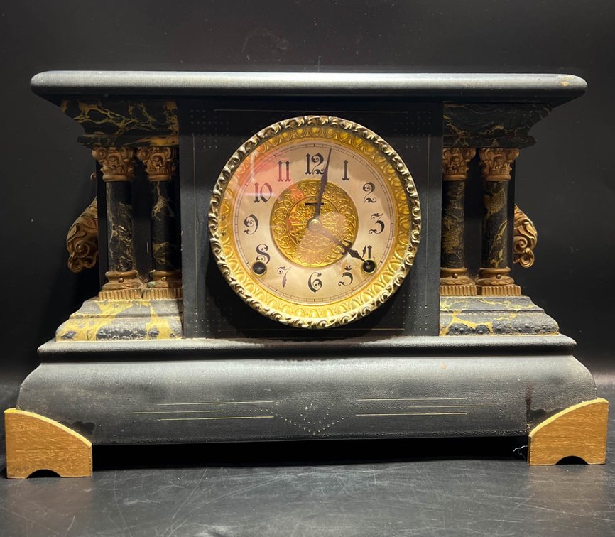 Black Mantel Clock with Ornate Detailing and Four Columns