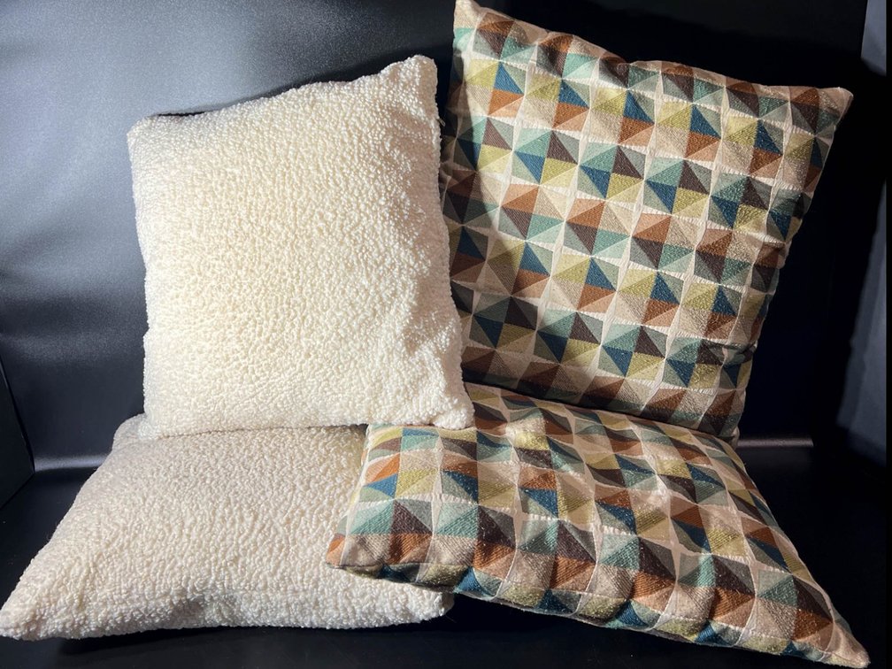 Four Decorative Throw Pillows with Geometric and Sherpa Textures