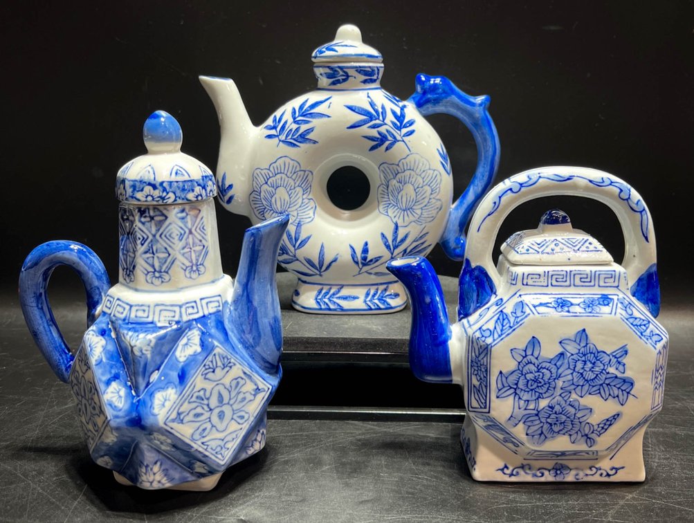 Three Blue and White Ceramic Teapots with Floral Designs