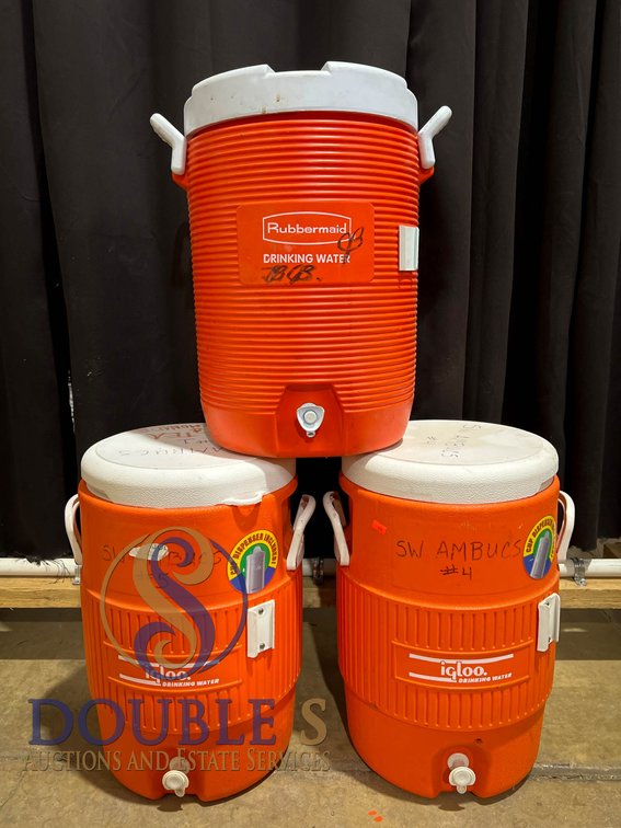 Three Orange Rubbermaid and Igloo Water Coolers With Spigots