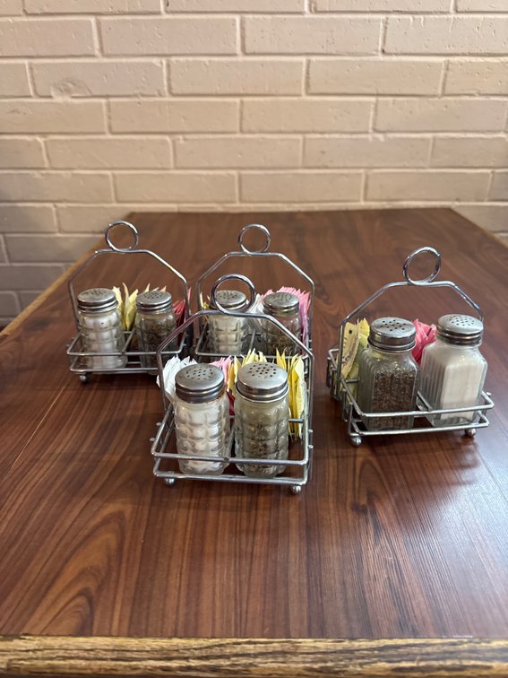 Four Stainless Steel Tabletop Condiment Holders with Shakers and Packets