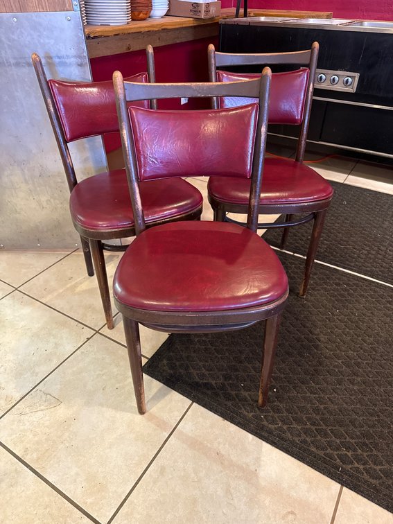Three Wooden Chairs with Maroon Vinyl Upholstery, One with Missing Top Support