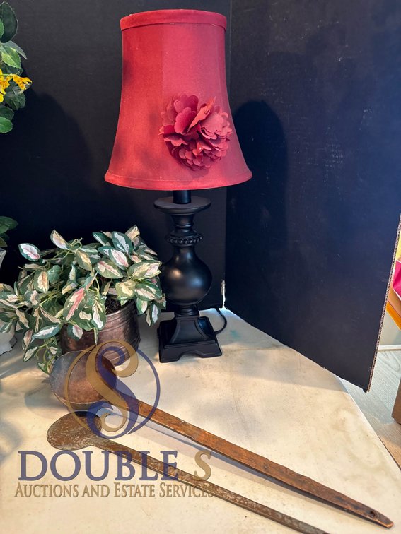 Black Table Lamp with Red Fabric Shade, Decorative Plant, and Two Long Copper Spoons