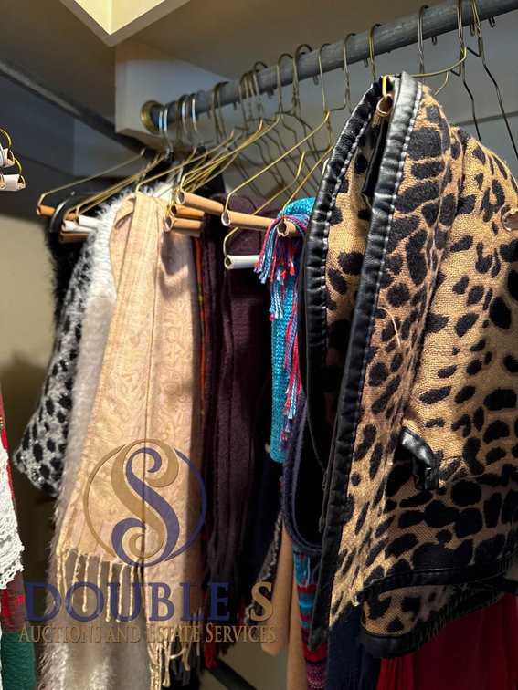 Scarves and Wraps on Hangers in Various Textures and Prints