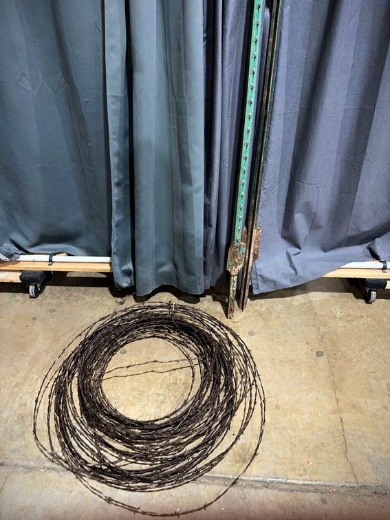 Roll of Barbed Wire with Metal Fence Posts