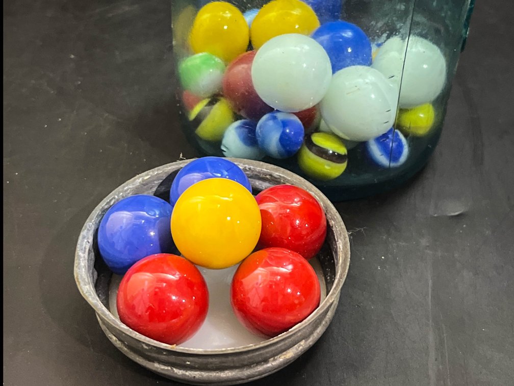 7” Glass jar of marbles 
