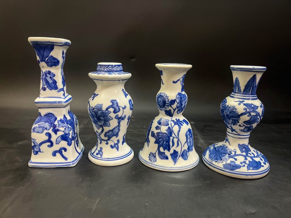 Four porcelain candle stick holders