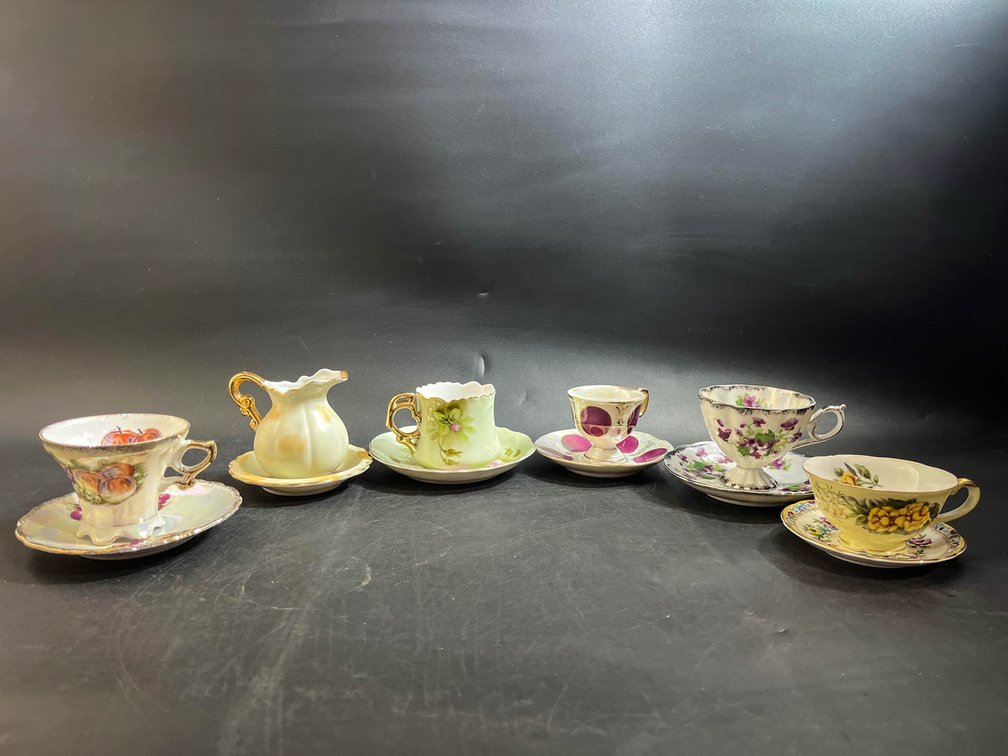 Teacups with saucers and creamer