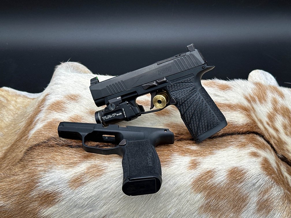 Sig Sauer P365 9 mm pistol with Streamlight TLR-7 light in original box. 