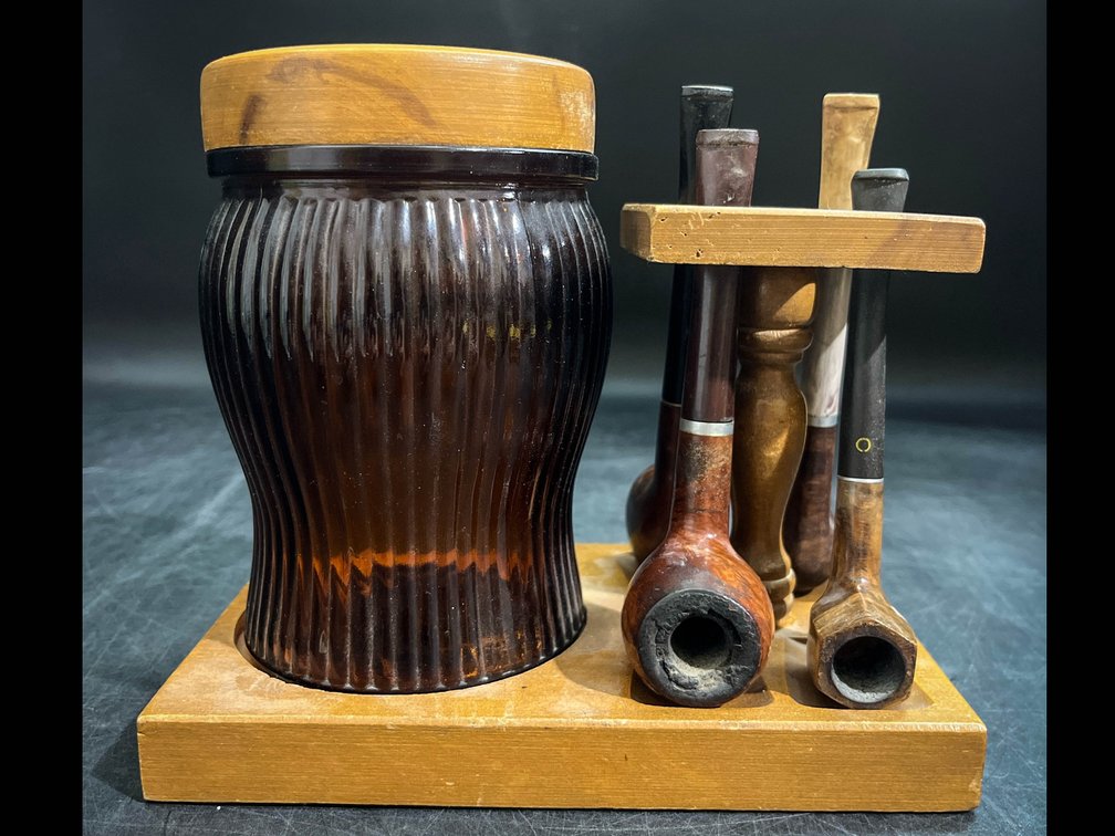 Vintage tobacco pipe display with tobacco pipes and jar 