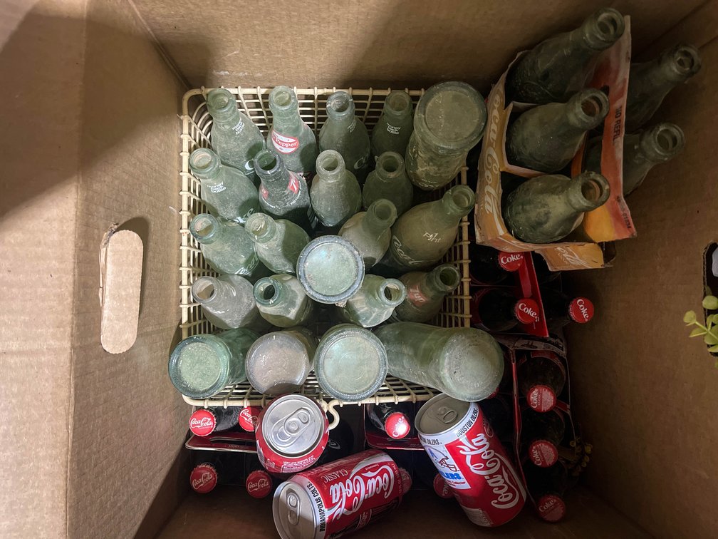 Collection of Coca-Cola bottles full and Empty 