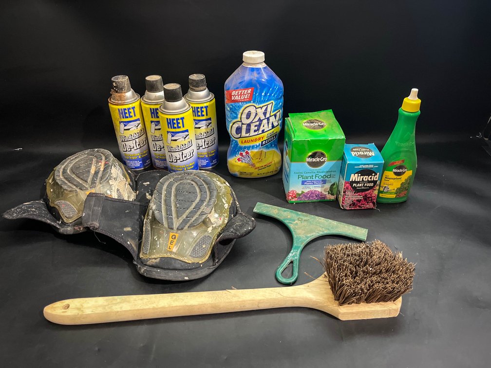 Kneepads, brush, windshield De-Icer, plant food, OxiClean for laundry, and Squeegee  
