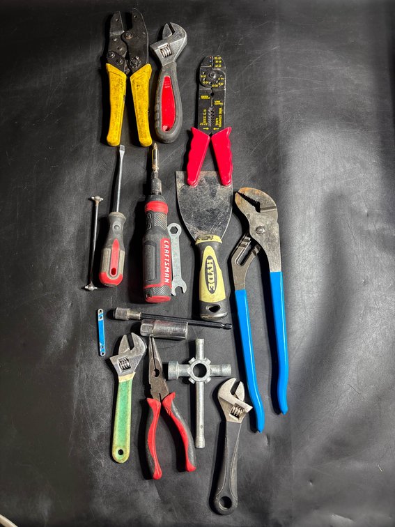 Selection of Hand Tools Including Pliers, Wrenches, and Screwdrivers