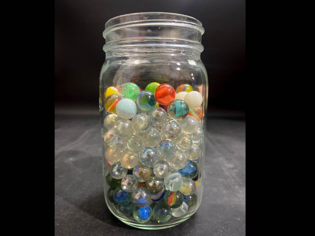 6.5” glass jar of Marbles