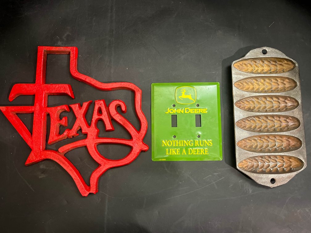 11” cast iron texas sign, John Deere lightswitch plate, cast iron corn bread pan