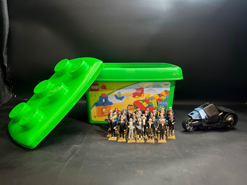 Lego Duplo set, miniature figurines of U.S. Presidents, and Batman on bike toy 