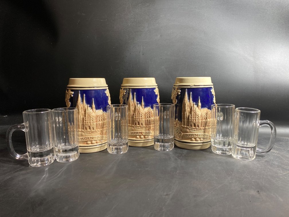 Three German-Themed Ceramic Steins and Four Miniature Glass Mugs