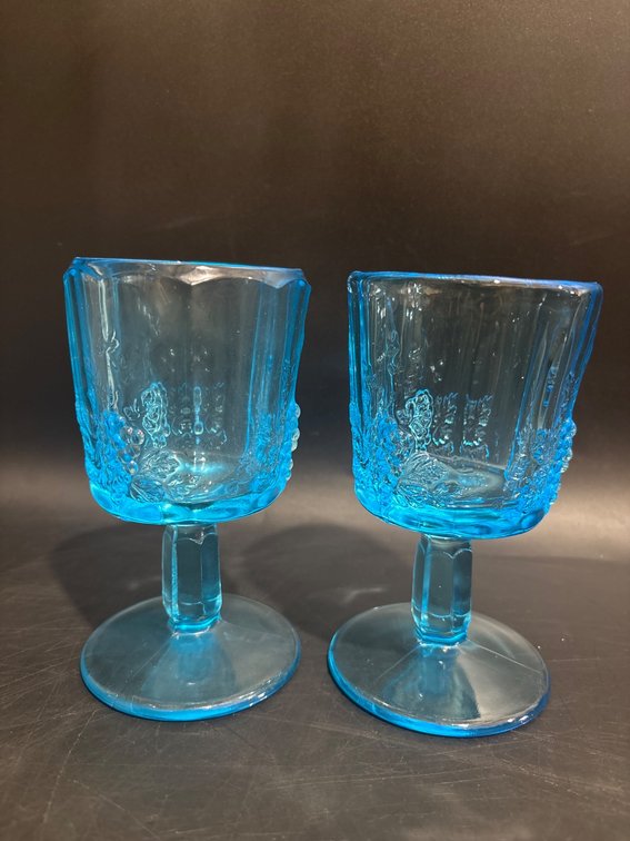 Blue Glass Goblets with Grape Motif and Glowing Effect Under UV Light