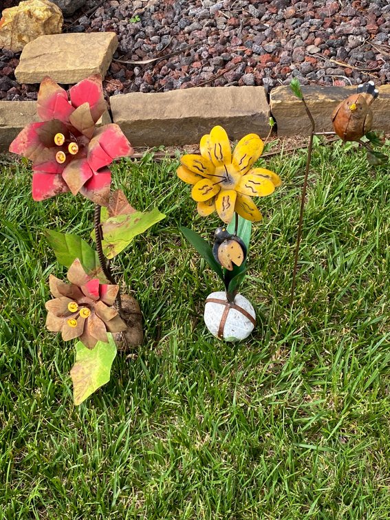 Three Metal Yard Art Flowers with Heights of 23”, 27”, and 27”