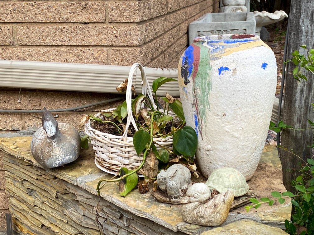 Outdoor Decor Including Ceramic Pot, Duck Figurine, and Planter Basket