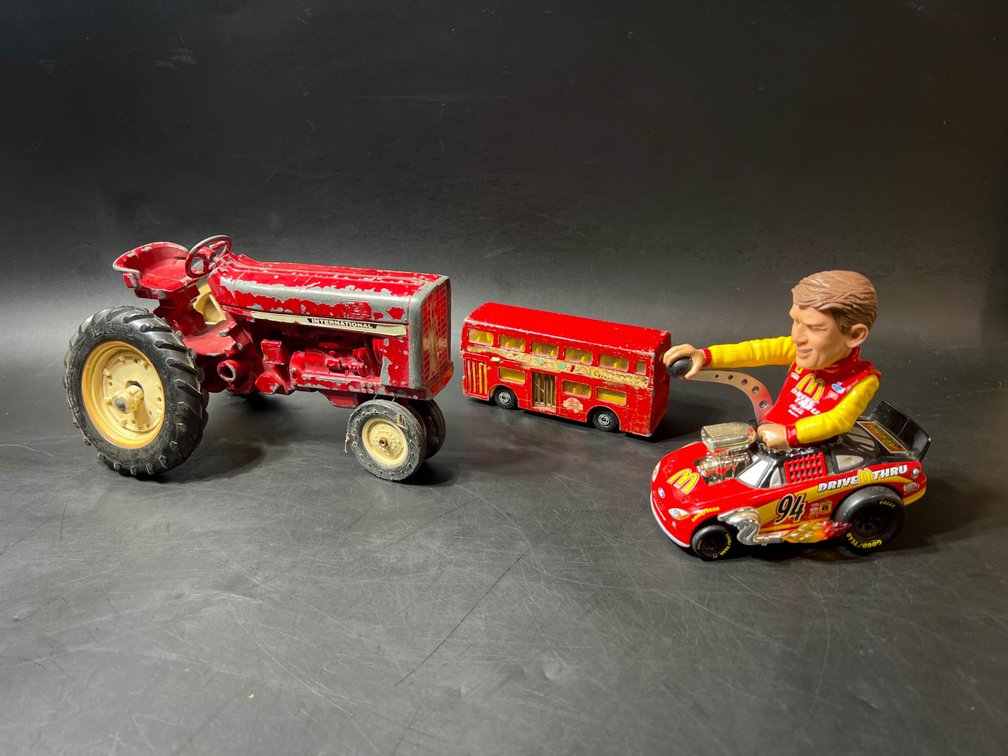 Three Vintage Toy Vehicles Including Tractor, Double-Decker Bus, and NASCAR Car