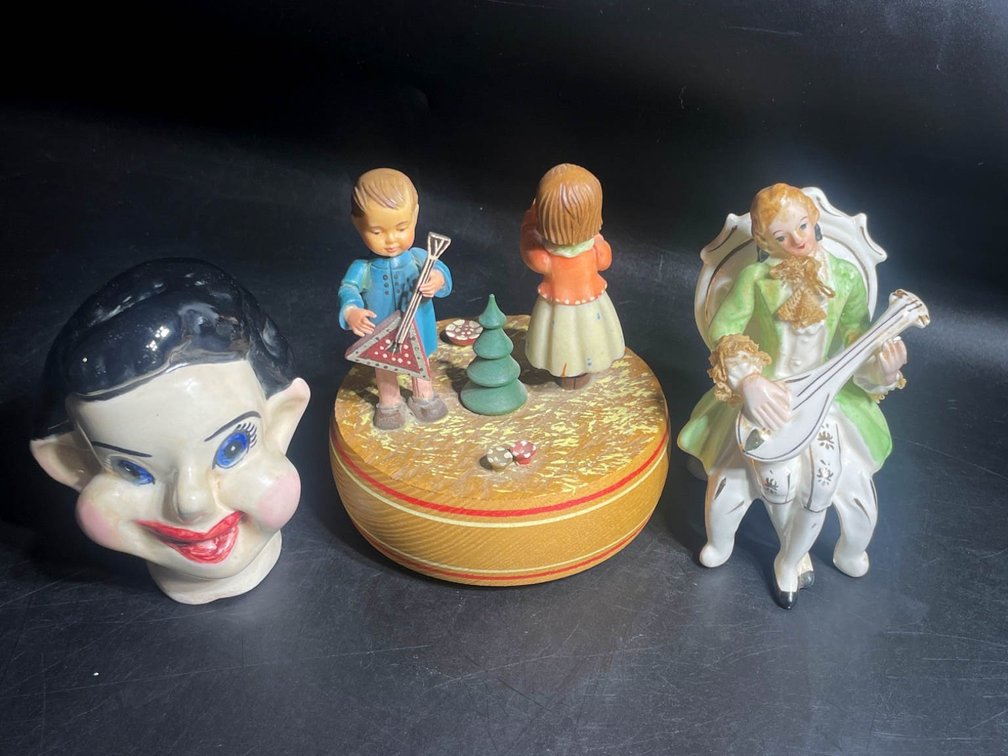 Three Decorative Figurines and a Head Sculpture