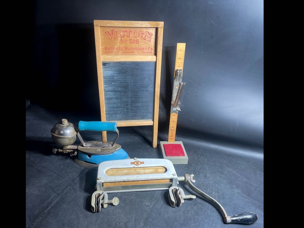 Vintage Laundry and Sewing Tools Including Washboard, Iron, Wringer, and Skirt Marker