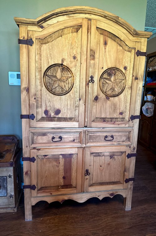 Rustic Wooden Armoire With Star Designs on Doors
