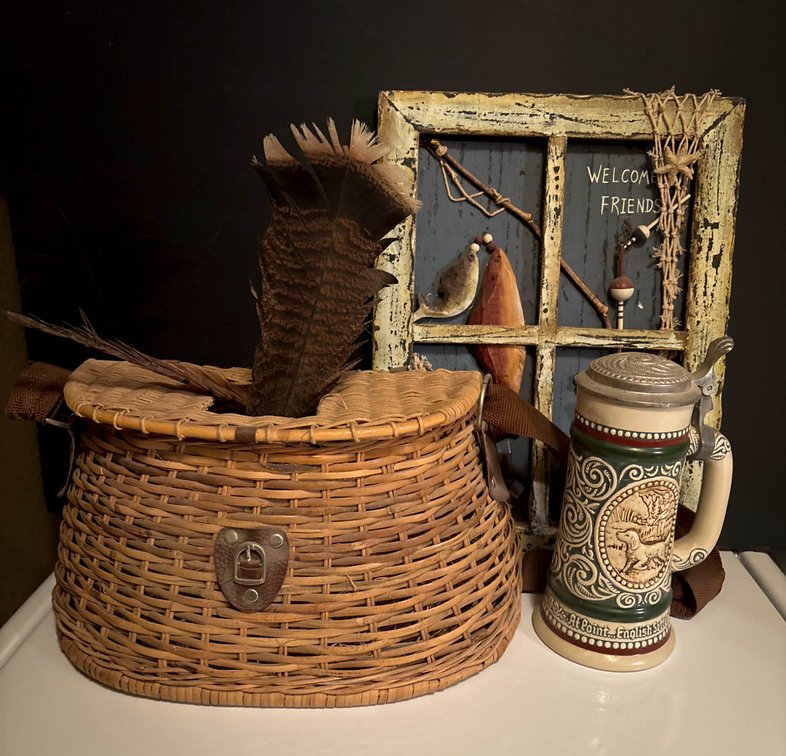 Decorative Items Including Wicker Basket, Fishing Themed Artwork, and Stein